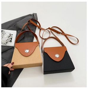 Detail of color-block box bags featuring woven texture and brown leather straps