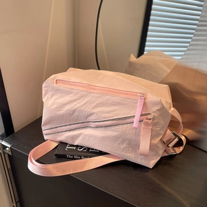 Versatile light pink canvas shoulder bag with multiple zippers for sports and travel