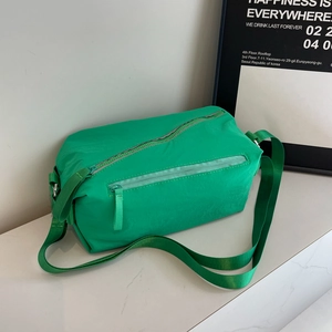 Versatile bright green nylon crossbody bag with adjustable wide strap for outdoor travel