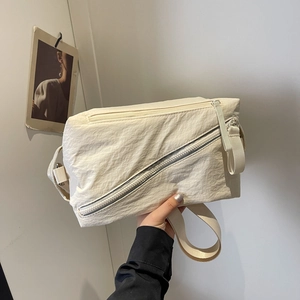 Cream white nylon crossbody bag with textured fabric and adjustable strap in main view