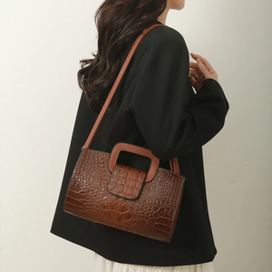 Brown crocodile embossed tote bag with unique square cutout handle and slim shoulder strap