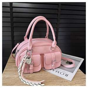 Sac à bandoulière rose verni avec poches avant et cadenas en cœur sur bois