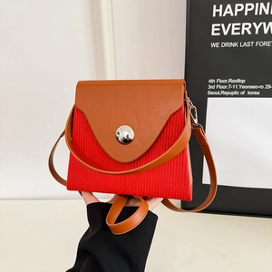 Contrast color patchwork shoulder bag with pleated texture and silver buckle detail