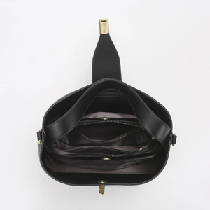Internal view of black bucket bag featuring zippered compartments and gold metal hardware
