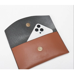 Detail showing internal storage space for a smartphone in a brown lychee pattern bag