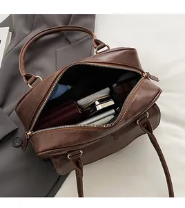 Top view of spacious interior in dark brown vintage leather bag with double zippers