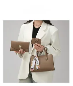 Detailed set of brown leather tote bag with floral scarf handle, wallet, and card holder