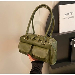 Detail of vintage green high-capacity tote bag with dual magnetic pockets and gold hardware