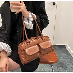 Brown vintage Boston handbag detail showing the textured leather and double front pockets