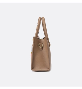 Detail view of brown pebbled leather tote with decorative silk scarf tied to handle