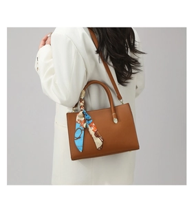 Brown litchi grain leather handbag with decorative printed scarf and gold feet studs