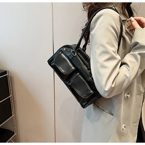 Glossy black retro shoulder bag with double pockets styled with a gray trench coat
