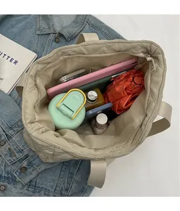 Detail view of large capacity quilted tote bag showing interior space and zipper