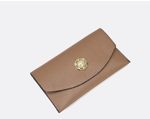 Detail of camel brown litchi pattern leather wallet with gold pearl heart clasp