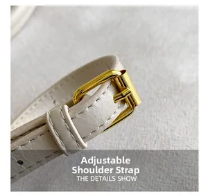 Detailed close-up of adjustable white leather shoulder strap with gold metallic buckle