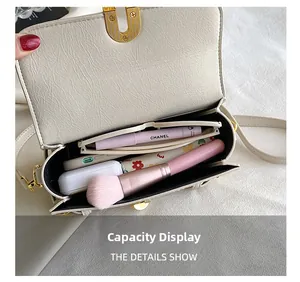 Detail view of cream leather crossbody bag interior showing daily essentials storage