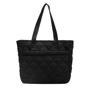 Minimalist black quilted tote bag with diamond pattern and webbed shoulder straps