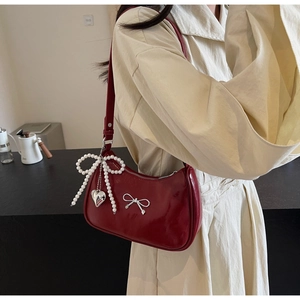 Deep red patent leather shoulder bag with silver bow buckle and pearl charms