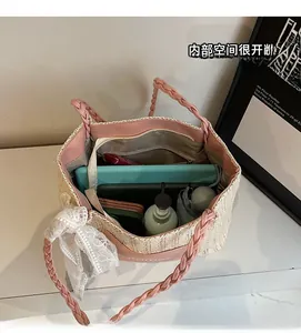 Top view of spacious straw tote interior with tablet, umbrella and pocket details