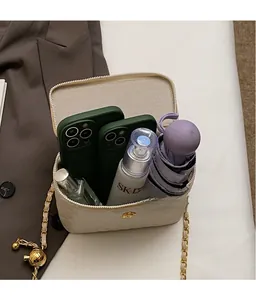Interior view of quilted chain bucket bag showing capacity for phone, perfume and umbrella