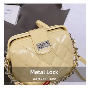 Detail showing the elegant silver metal twist lock and quilted leather texture of the bag