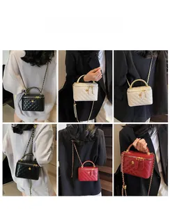 Quilted diamond chain bucket bag shown in black, white and red worn by a model