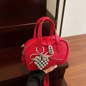 Red lychee pattern leather Boston handbag with silver mechanical lock and heart charm