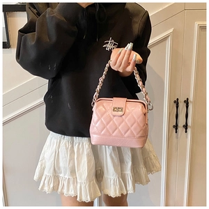 Detailed view of pink quilted PU leather crossbody bag with metal chain and twist lock