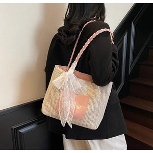 Detail of straw tote with pink handles, Summer patch and large white lace bow