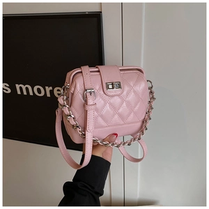 Detailed view of pink quilted handbag with silver twist lock and luxury metal chain strap
