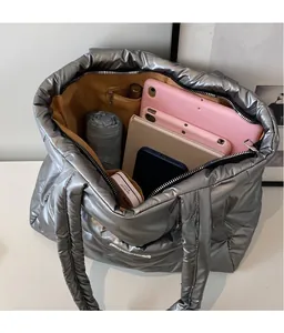 Macro view of large silver tote bag interior showing iPad and essentials in organized space