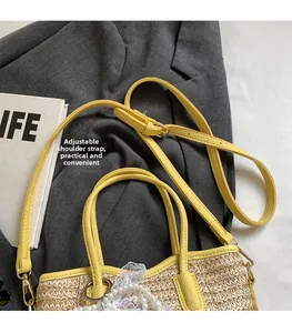 Detail of yellow straw bucket bag featuring adjustable strap, pearl trim, and lace accents