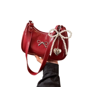 Glossy red bow baguette bag with pearl butterfly charm and silver heart pendant