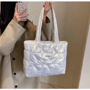 Close-up of white quilted puffer tote bag with Fashion & Bag label for daily commute