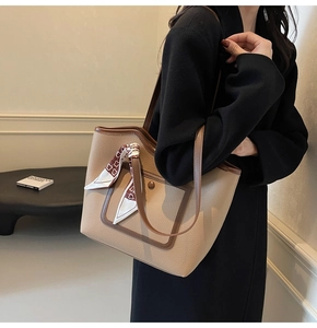 Detail of lychee pattern leather tote bag with silk scarf and metallic magnetic buckle