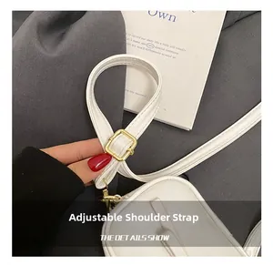 Detail of adjustable white synthetic leather strap with a gold square buckle