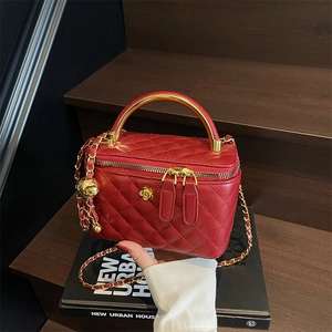 Red quilted leather mini bucket bag with gold handle and chain strap for women