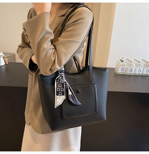 Detail of black lychee grain tote bag with decorative silk scarf and front pocket