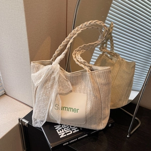 Large straw tote bag with Summer embroidery, lace bow, and braided handles for beach travel