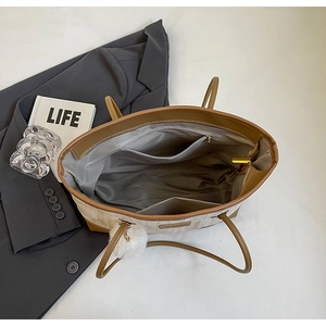 Detail of spacious tote bag interior with zipper pocket and brown contrast texture