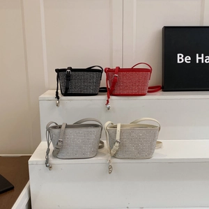 Detail view of mini bucket bags in four colors with sparkling rhinestones and adjustable strap