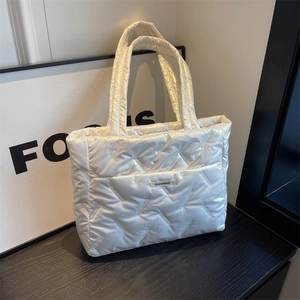 White quilted tote bag with a glossy finish and large capacity for casual commuting