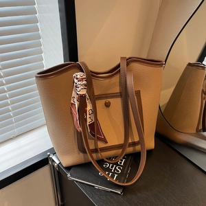 Large khaki lychee leather tote bag with brown contrast trim and decorative silk scarf