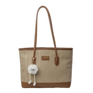 Minimalist color-block tote bag in beige fabric and brown leather with fuzzy charm