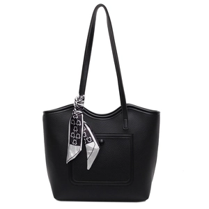 Large black leather tote bag with silk scarf decoration and front pocket detail