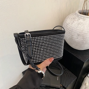Minimalist black lychee leather underarm bag with silver rivets and metal charm