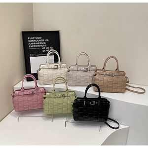 Collection of hand-woven crossbody bags in six colors with metallic buckle details