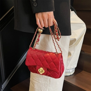 Classic red quilted shoulder bag with golden petal clasp and leather chain strap