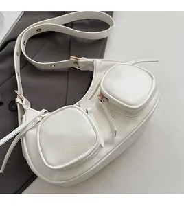 White crescent crossbody bag with wrinkled leather texture and dual zipper pockets