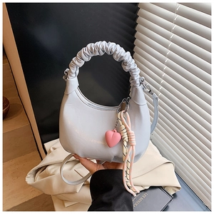 Light blue half-moon hobo bag with cloud-like ruched handle and heart charm detail